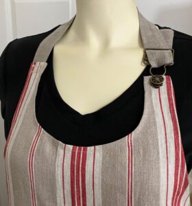 Scoop neckline with adjustable strap with overall buckle..