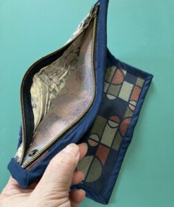 Zippered pouch includes slots for 6 ID/credit cards