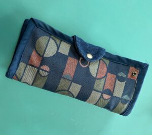 Remove insert from DEI bag and use tab snap to fold into a clutch wallet